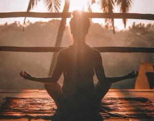 Woman in yoga pose in sunshine