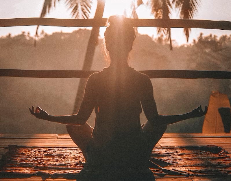 Woman in yoga pose in sunshine